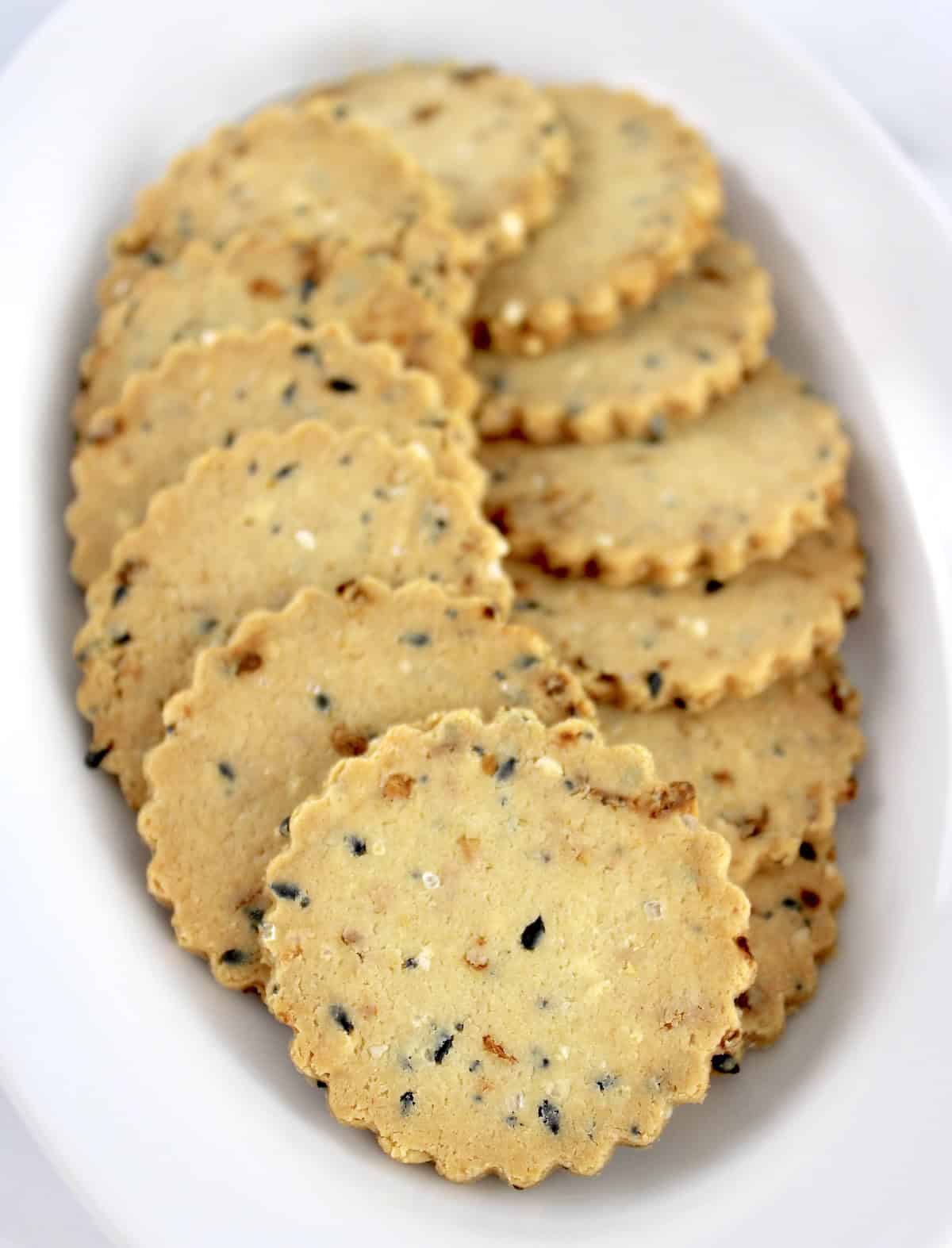 Everything Bagel Crackers arranged in a circle on white oval plate