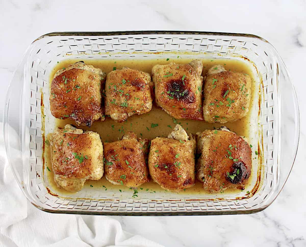 8 Honey Mustard Baked Chicken Thighs in glass casserole baking dish