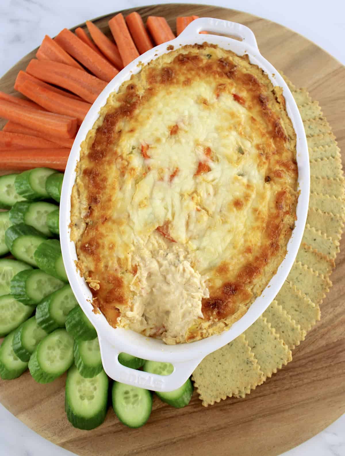 overhead view of Hot Crab Dip with carrots, crackers and cucumbers around