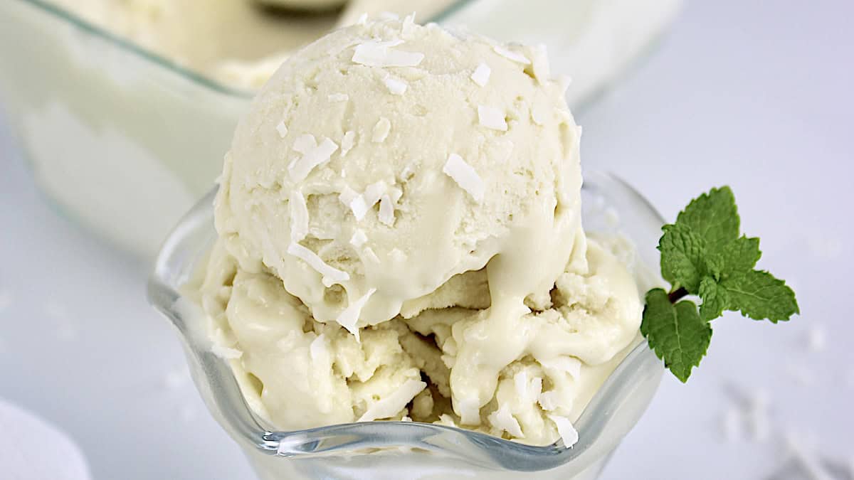 closeup of coconut ice cream in glass dish slightly melted