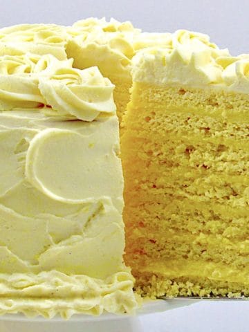 Keto Lemon Curd Layer Cake on cake stand with slice being removed