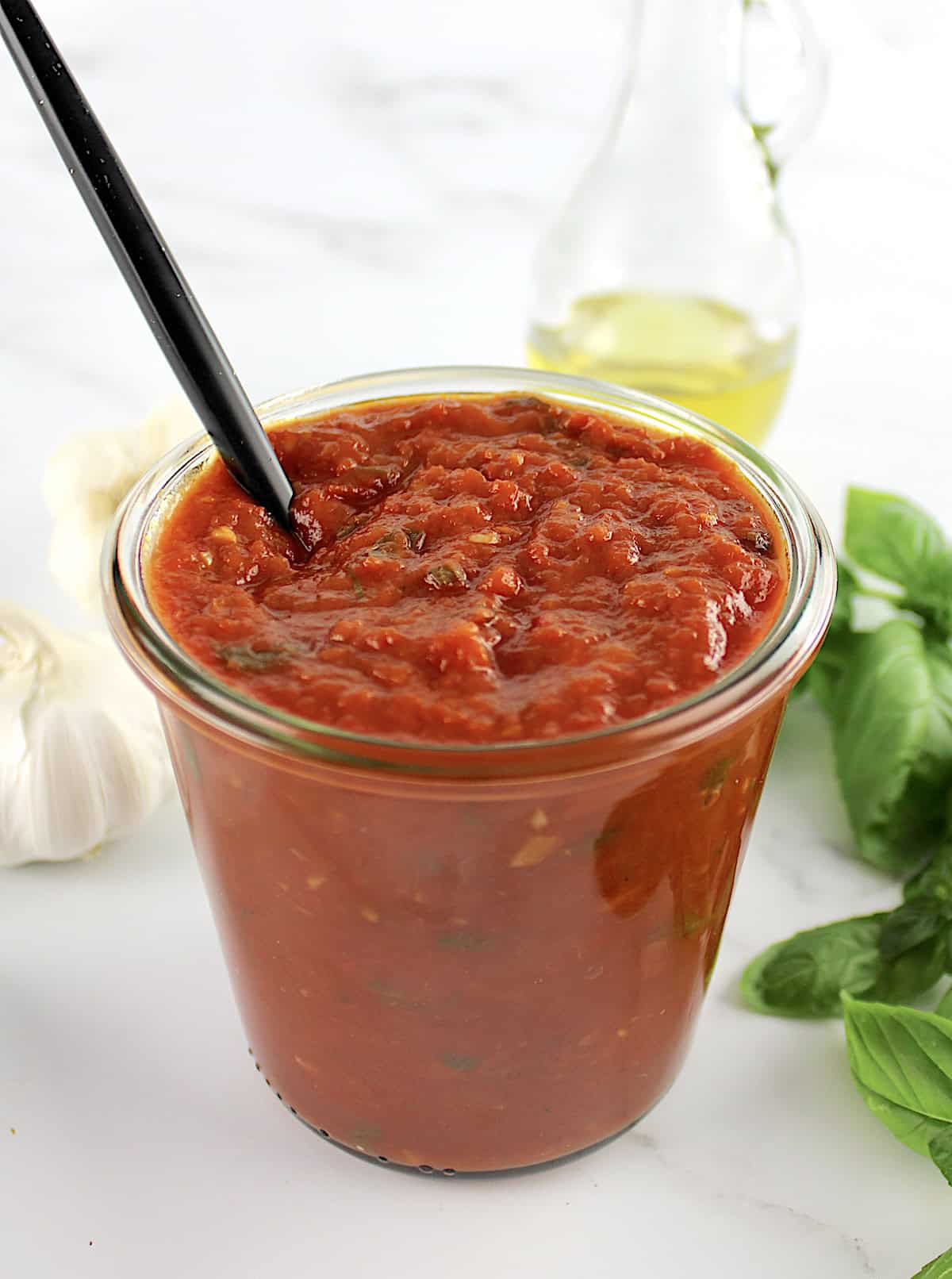 Keto Marinara Sauce in open glass jar with spoon