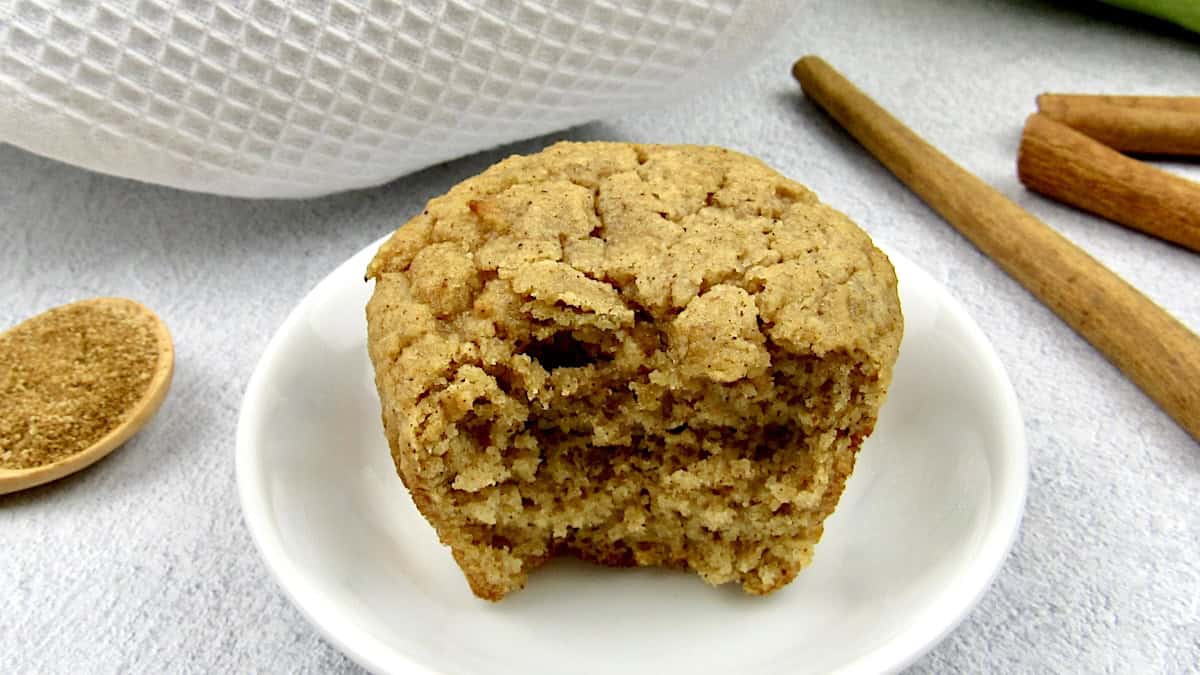 Keto Mock Apple Muffin on white plate with bite missing