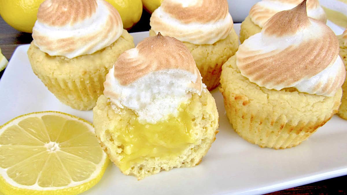 closeup of lemon meringue cupcake on white plate