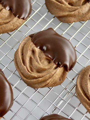 chocolate dipped Mocha Meringue Cookies on cooling rack