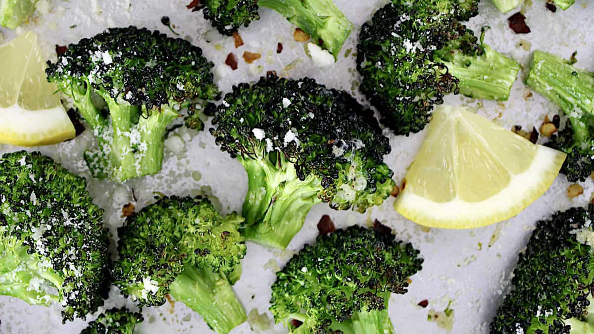 oven roasted broccoli on sheet pan with parmesan cheese and lemon slices