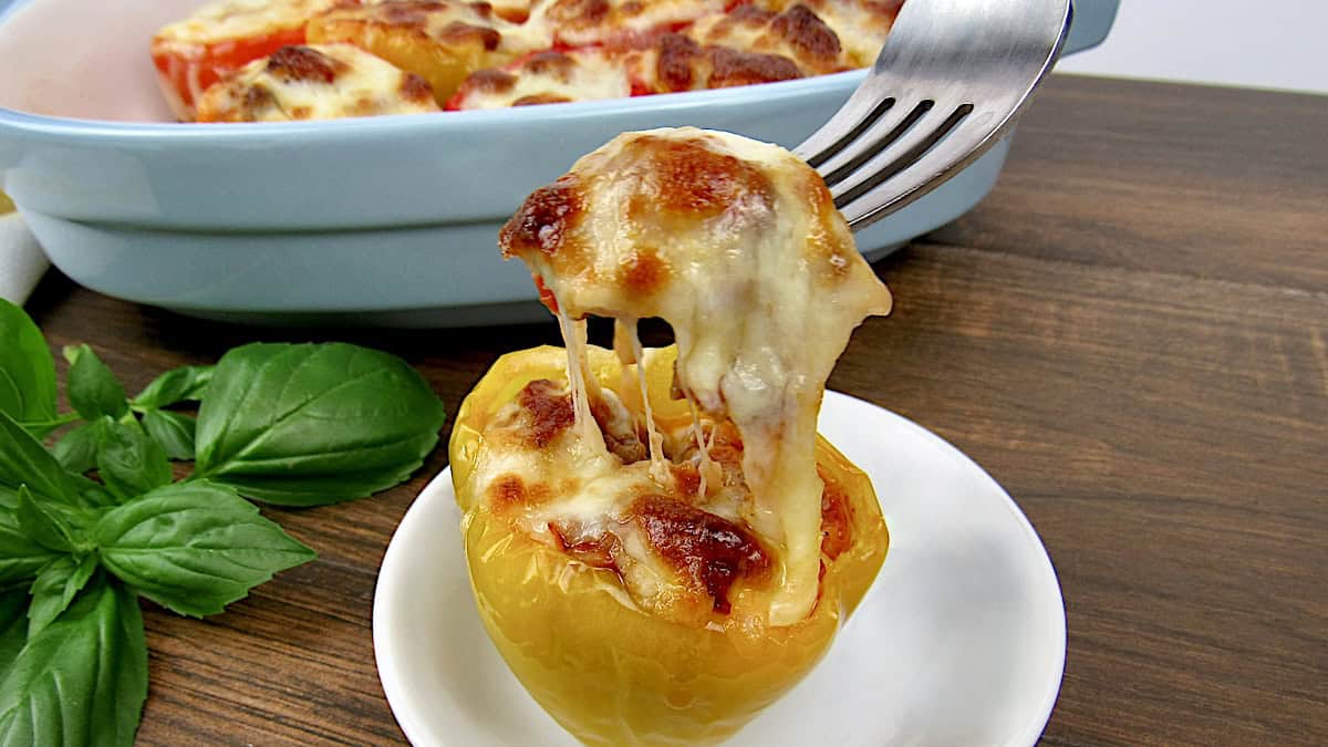 pizza stuffed pepper with fork pulling up cheese