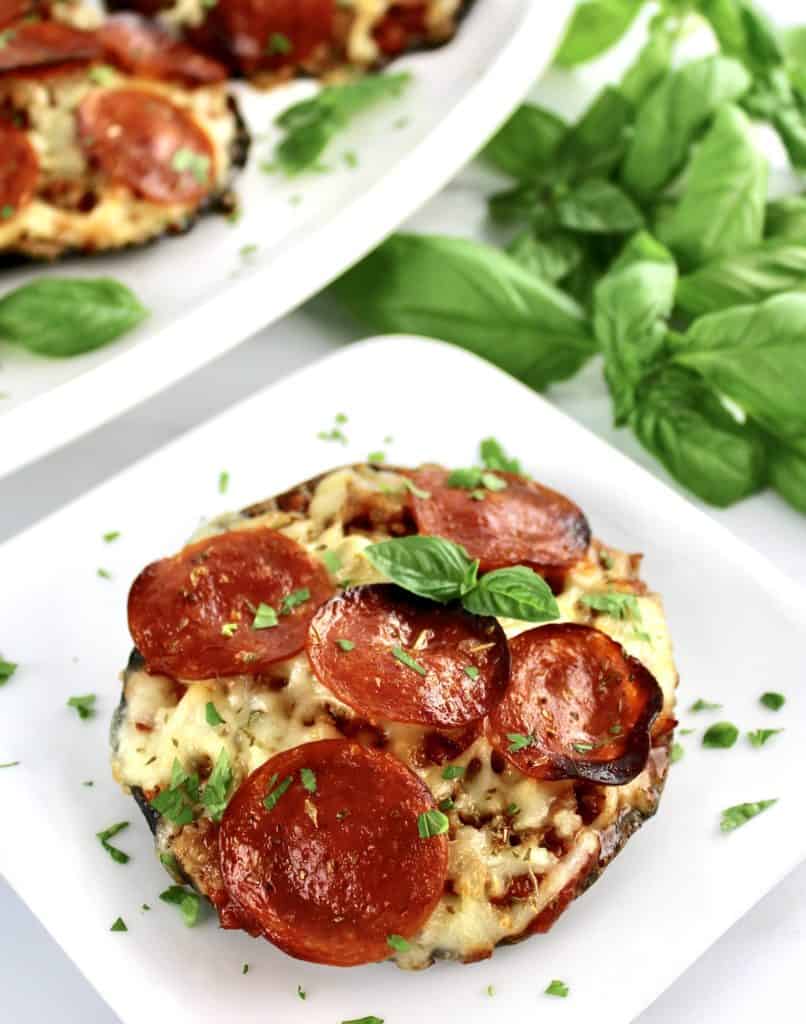 Portobello Mushroom Mini Pizza on white plate with fresh basil