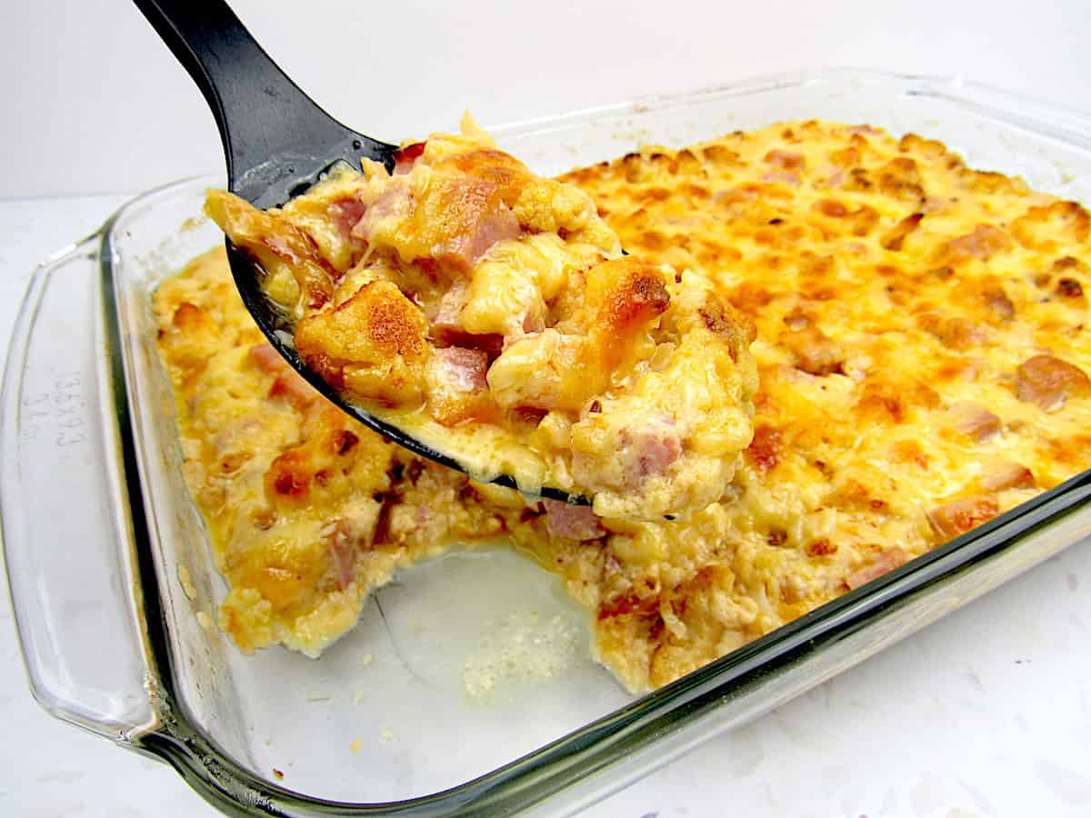 cauliflower and ham casserole with serving spoon ful