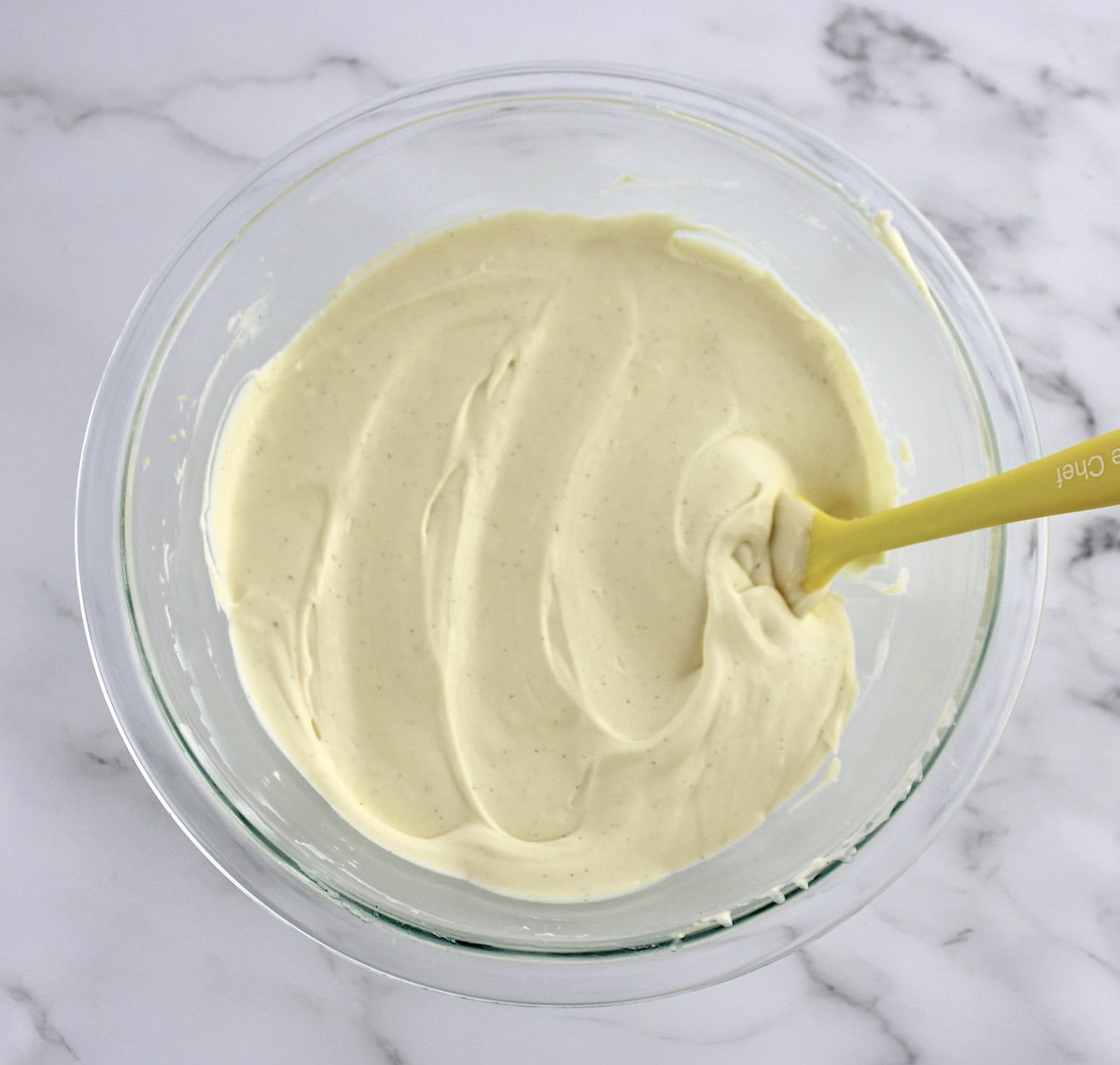 Vanilla Chocolate Chip Ice Cream base in glass bowl with yellow spoon