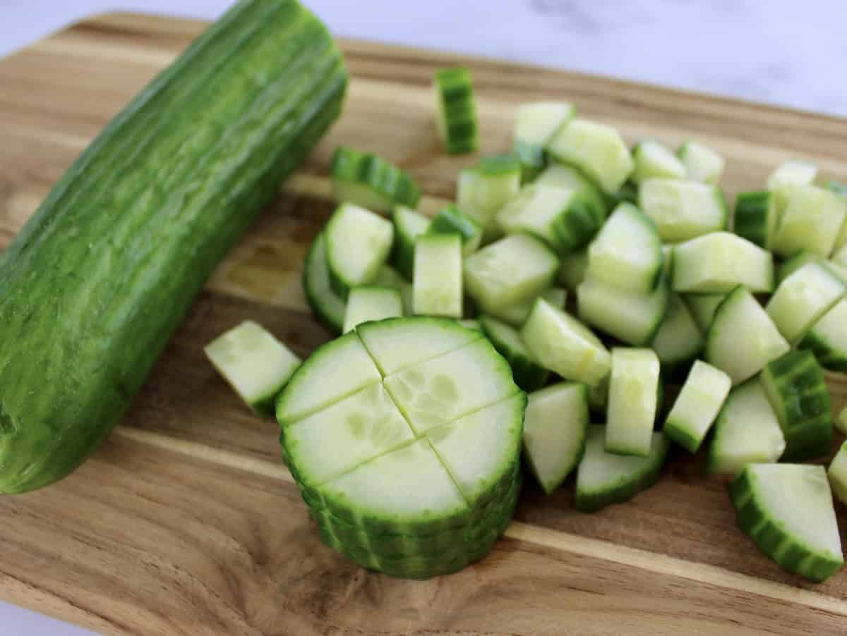 diced English cucumber on cutting board