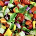 closeup of Israeli Salad with sprig of fresh mint in center