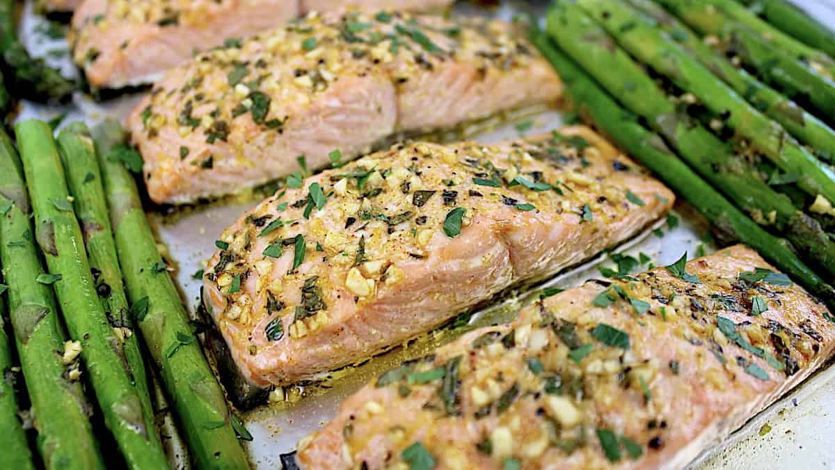 salmon on sheet pan with asparagus with garlic and chopped herbs