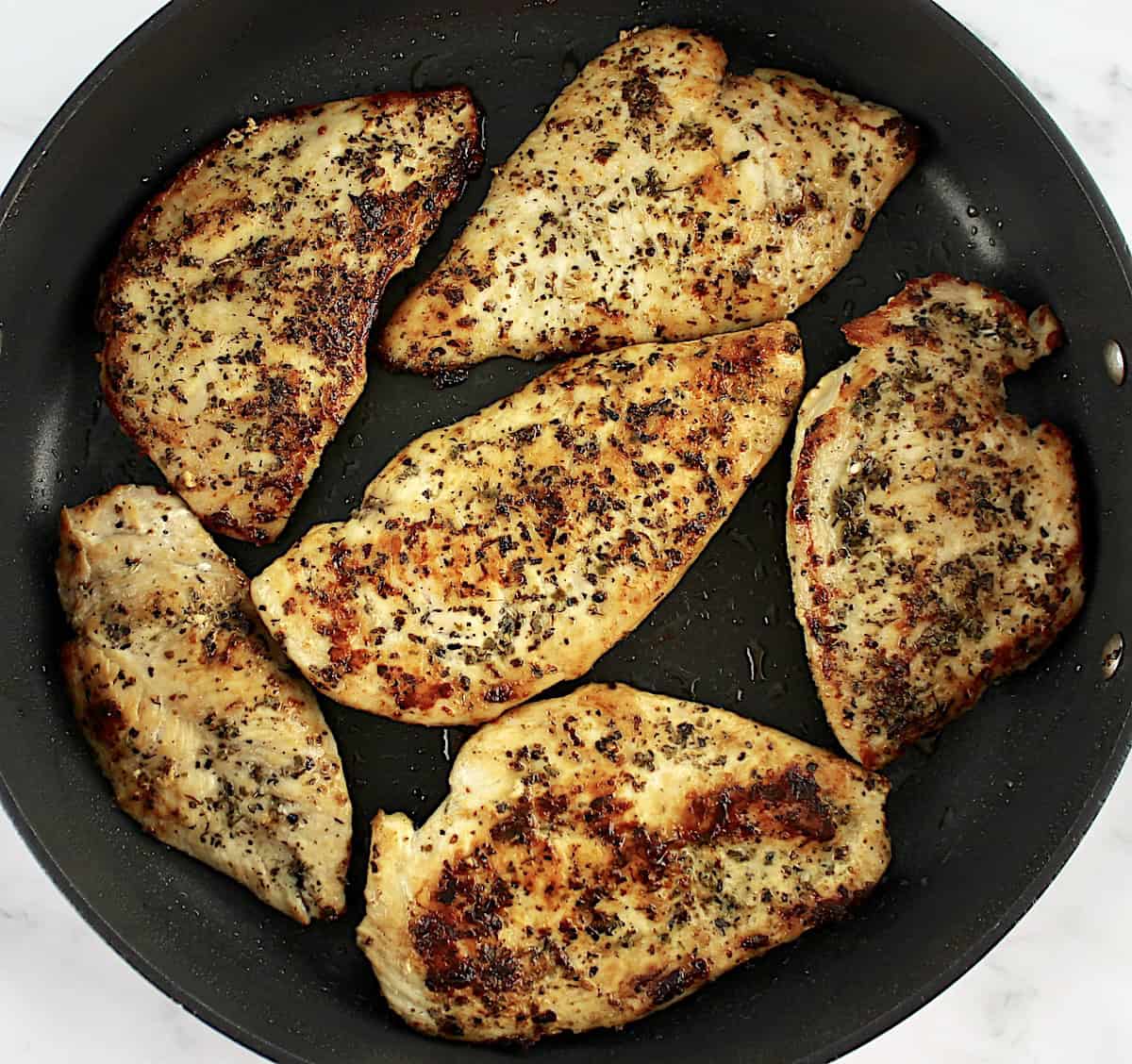 6 pieces of chicken breast in skillet cooked