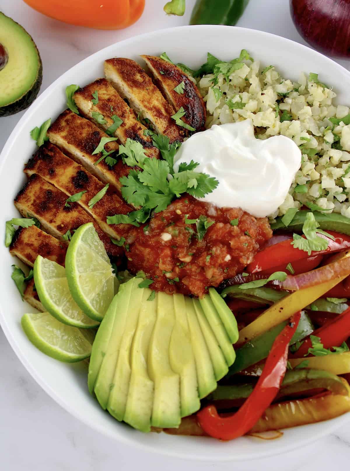 Chicken Fajita Bowl with dollop of sour cream and salsa