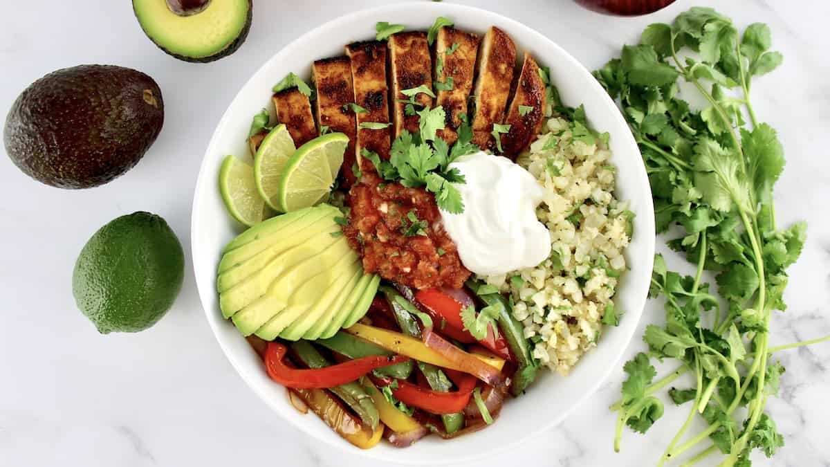 overhead view of Chicken Fajita Bowl with salsa and sour cream