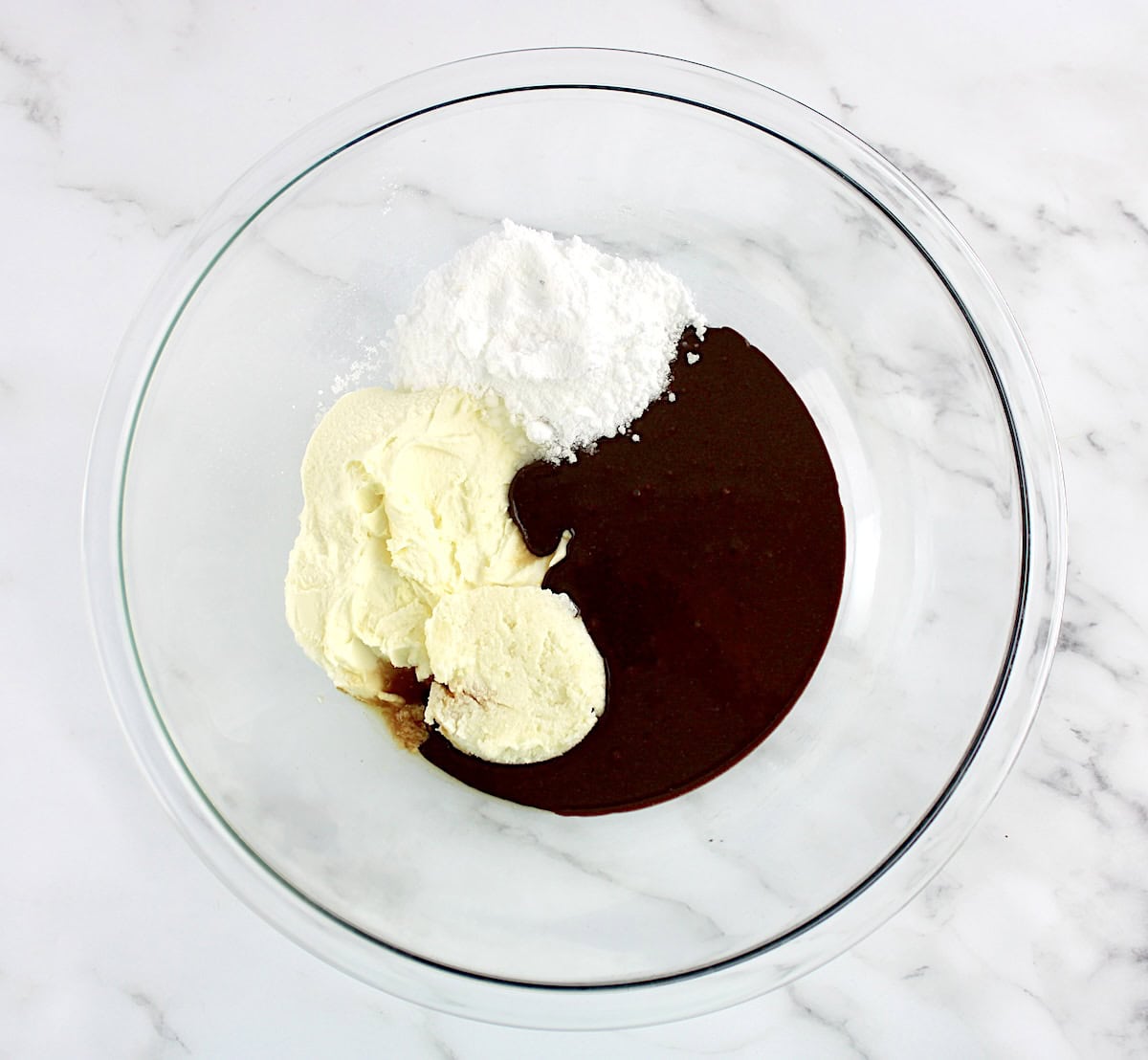 keto nutella, mascarpone and sweetener in glass bowl unmixed