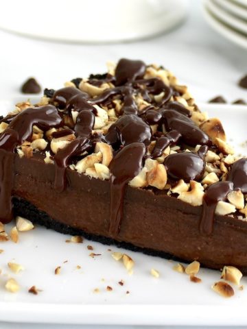 closeup of slice of Chocolate Hazelnut Tart on white plate