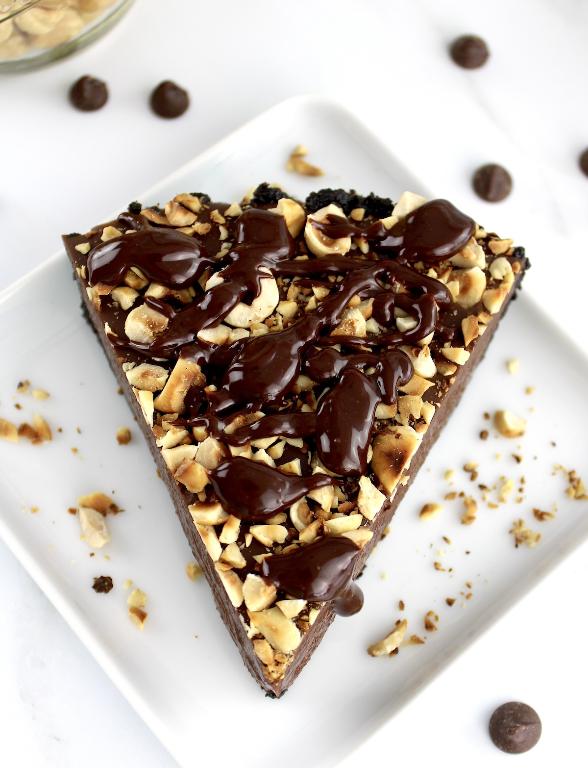 overhead view of slice of Chocolate Hazelnut Tart on white square plate