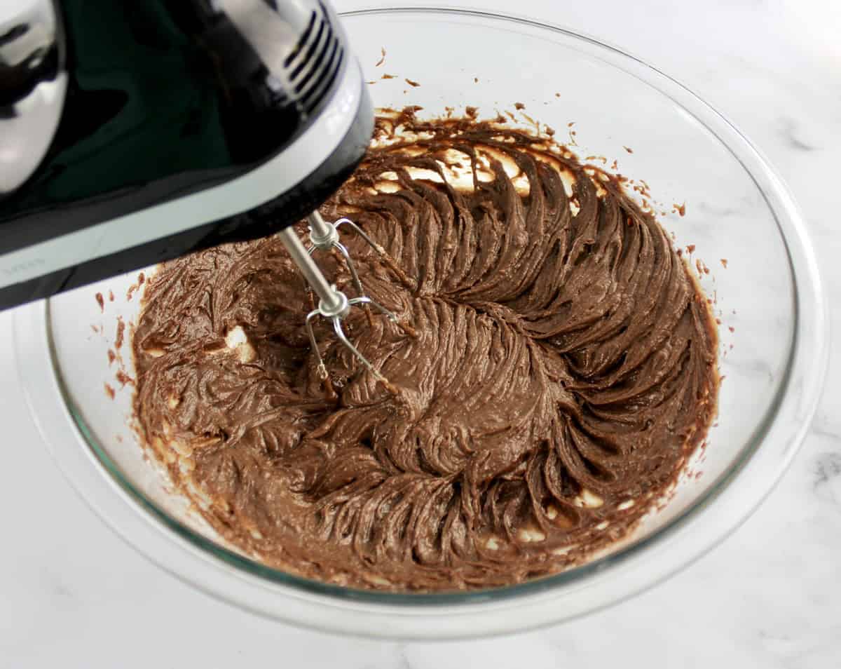 Chocolate Hazelnut Tart filling in glass bowl being mixed with hand mixer