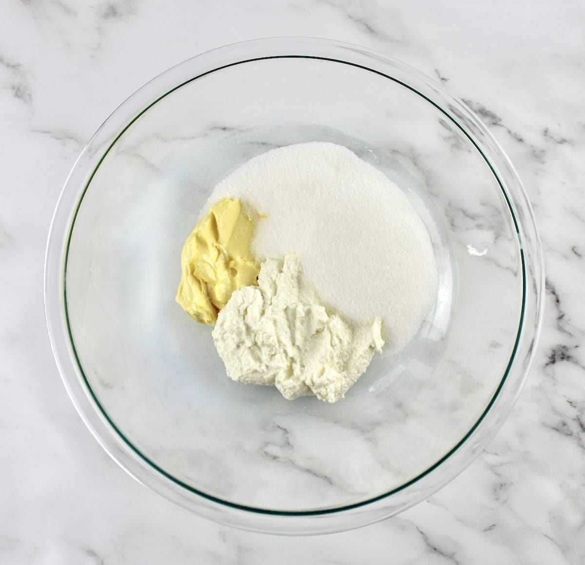 butter, ricotta and sweetener in glass mixing bowl