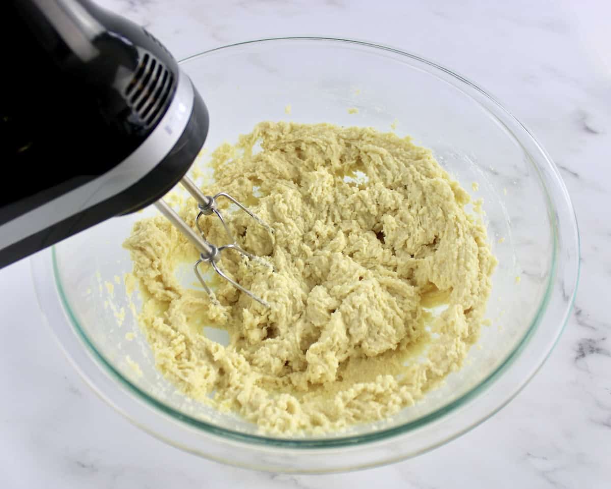 Lemon Ricotta Cookies cookie dough being mixer with hand mixer in glass bowl