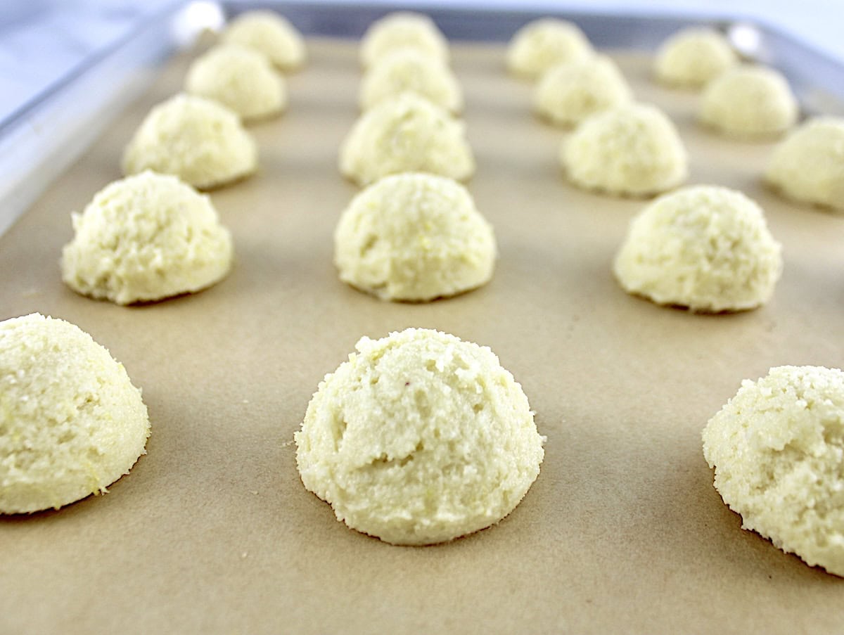 closeup of Lemon Ricotta Cookie dough balls on parchment paper