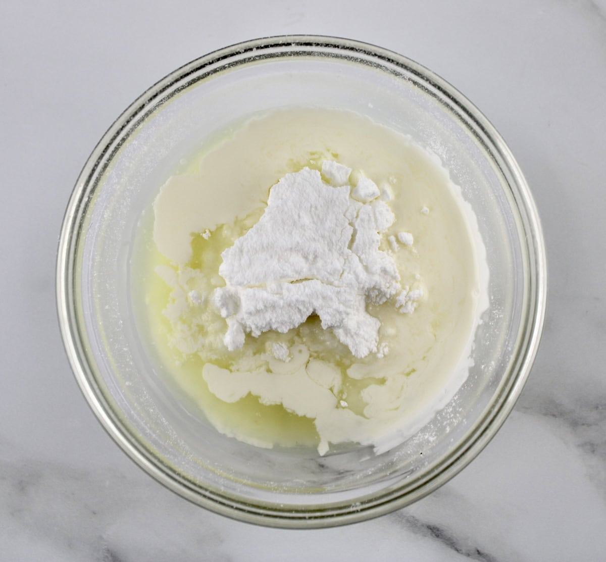 Lemon Ricotta Cookie glaze ingredients in glass bowl unmixed