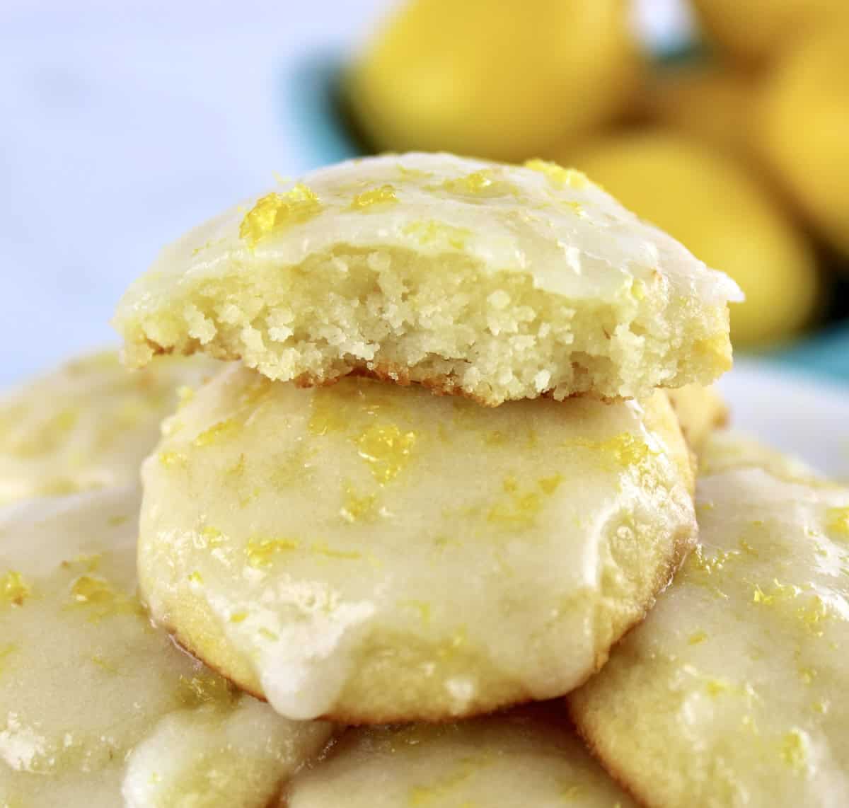 closeup of Lemon Ricotta Cookies stacked up with bite missing on the top cookie