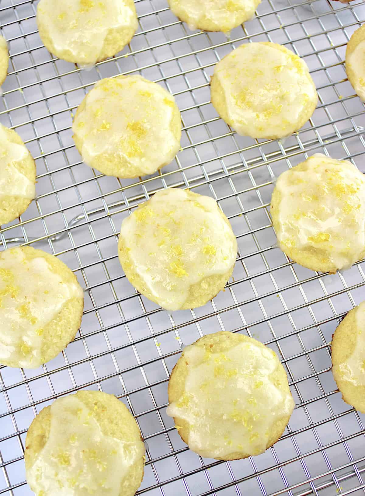 Lemon Ricotta Cookies on cooking rack with lemon glaze on the tops