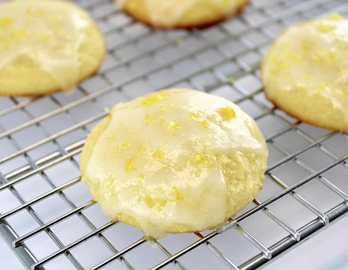 closeup of Lemon Ricotta Cookie with lemon glaze on cooling rack