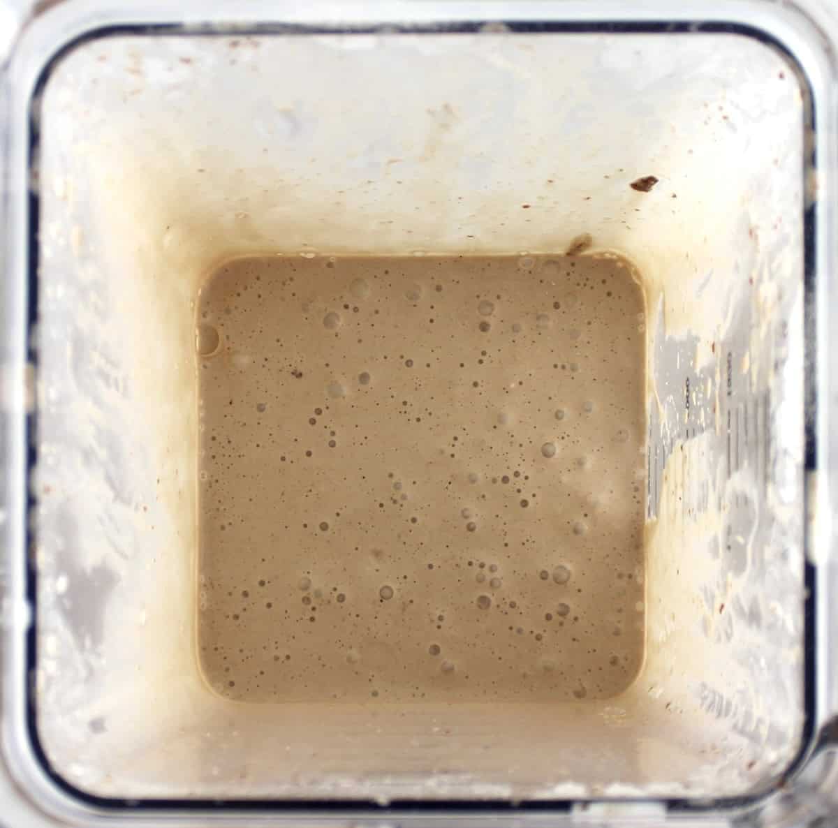 overhead view of Sugar-Free Nutella Protein Shake in blender bowl