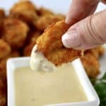 Air Fryer Chicken Nugget held up after dipping in honey mustard sauce