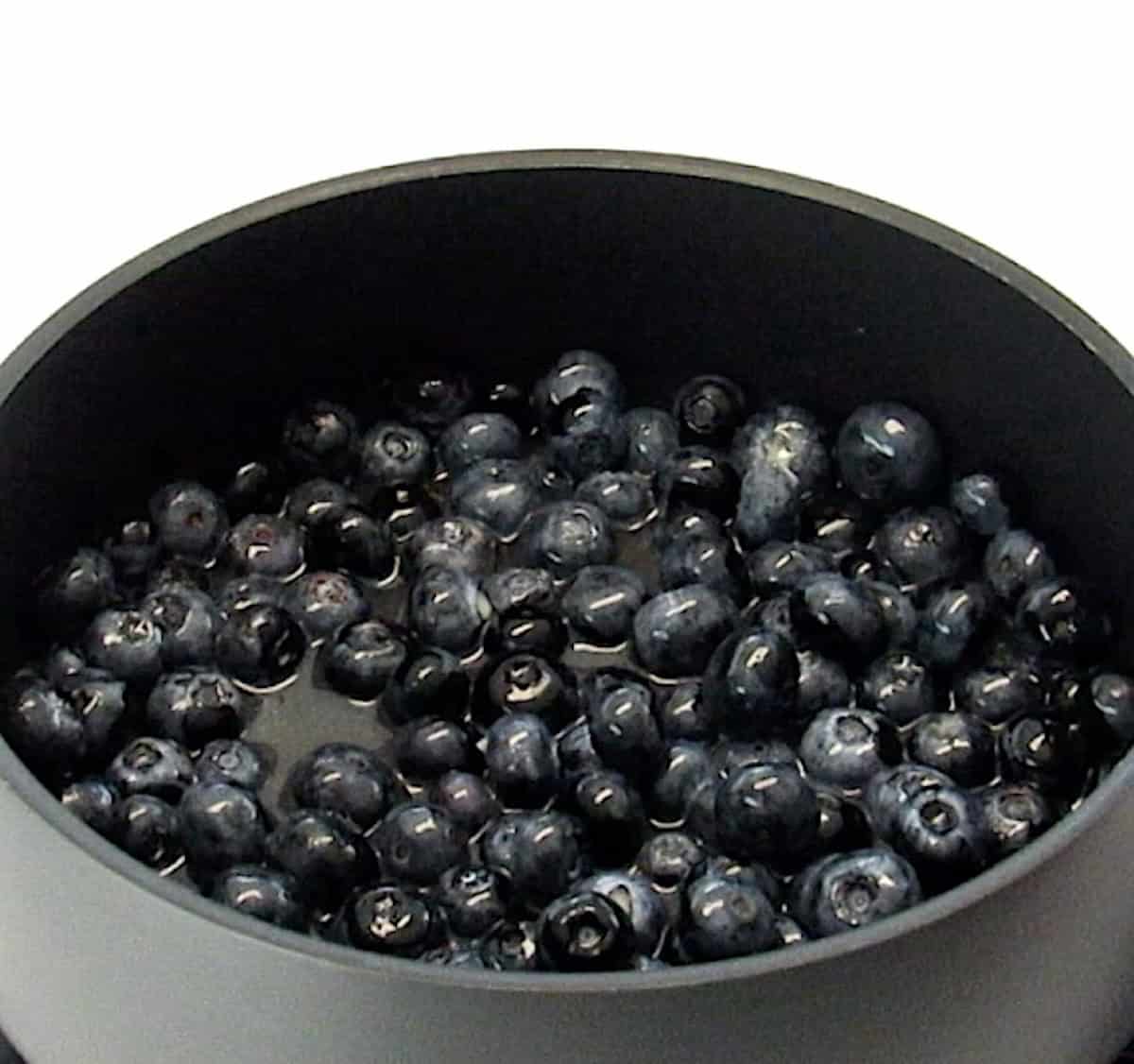 Keto Blueberry Sauce ingredients in saucepan