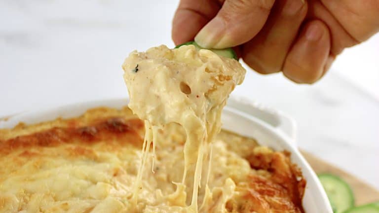 hot crab dip being pulled up with cheese pull