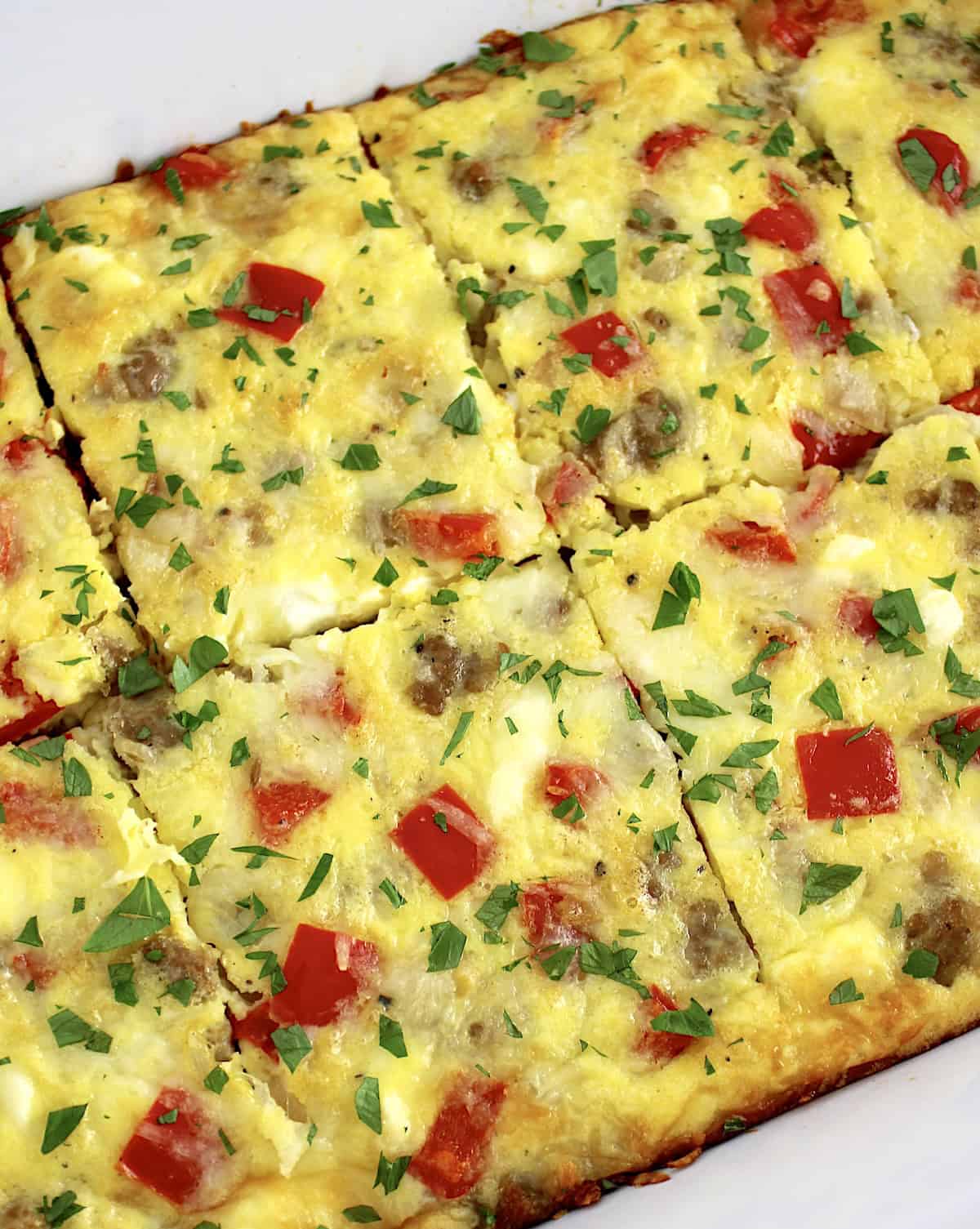 closeup overhead view of Sausage and Peppers Breakfast Casserole cut into 8 slices