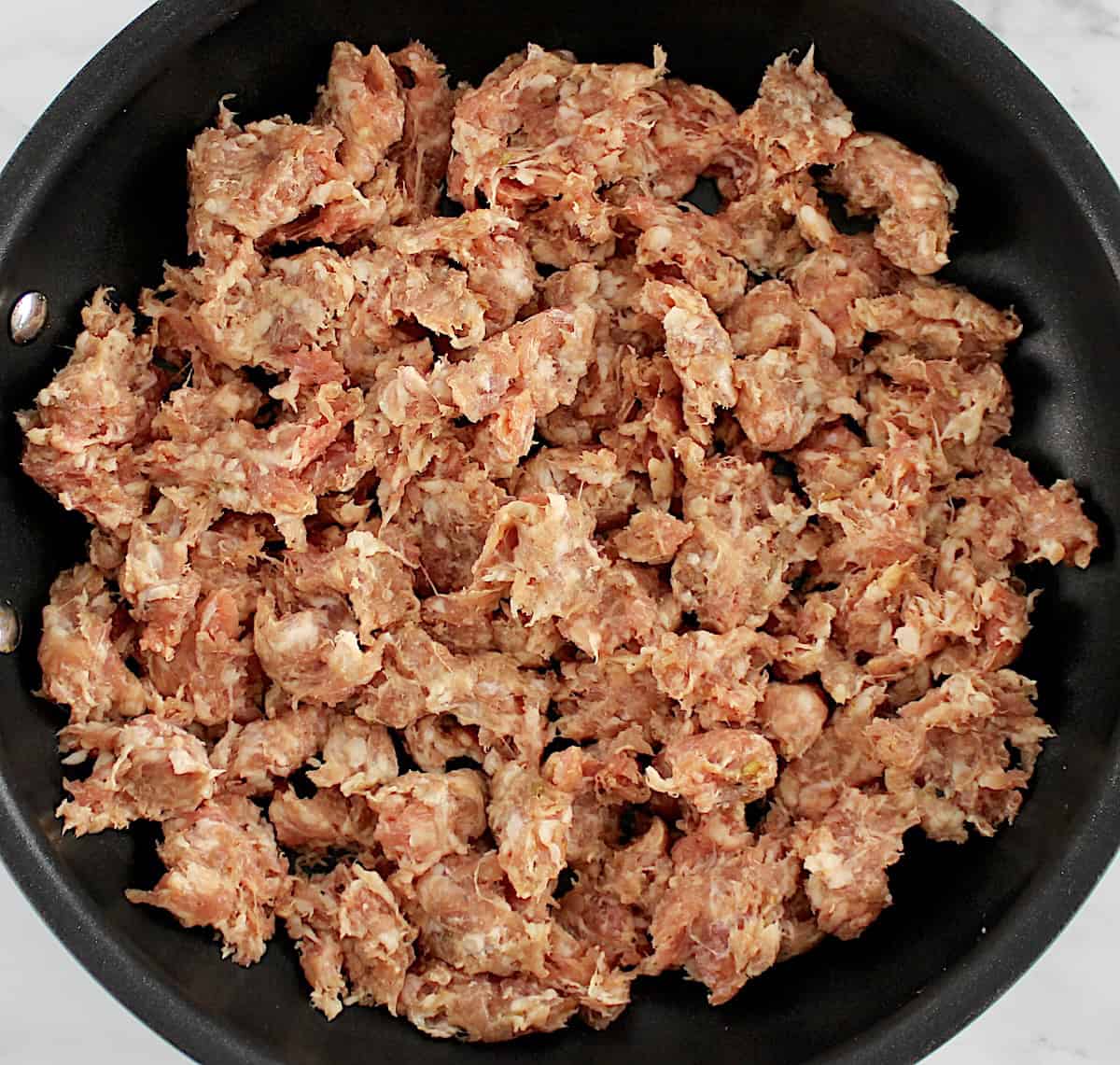 raw ground Italian sausage in skillet