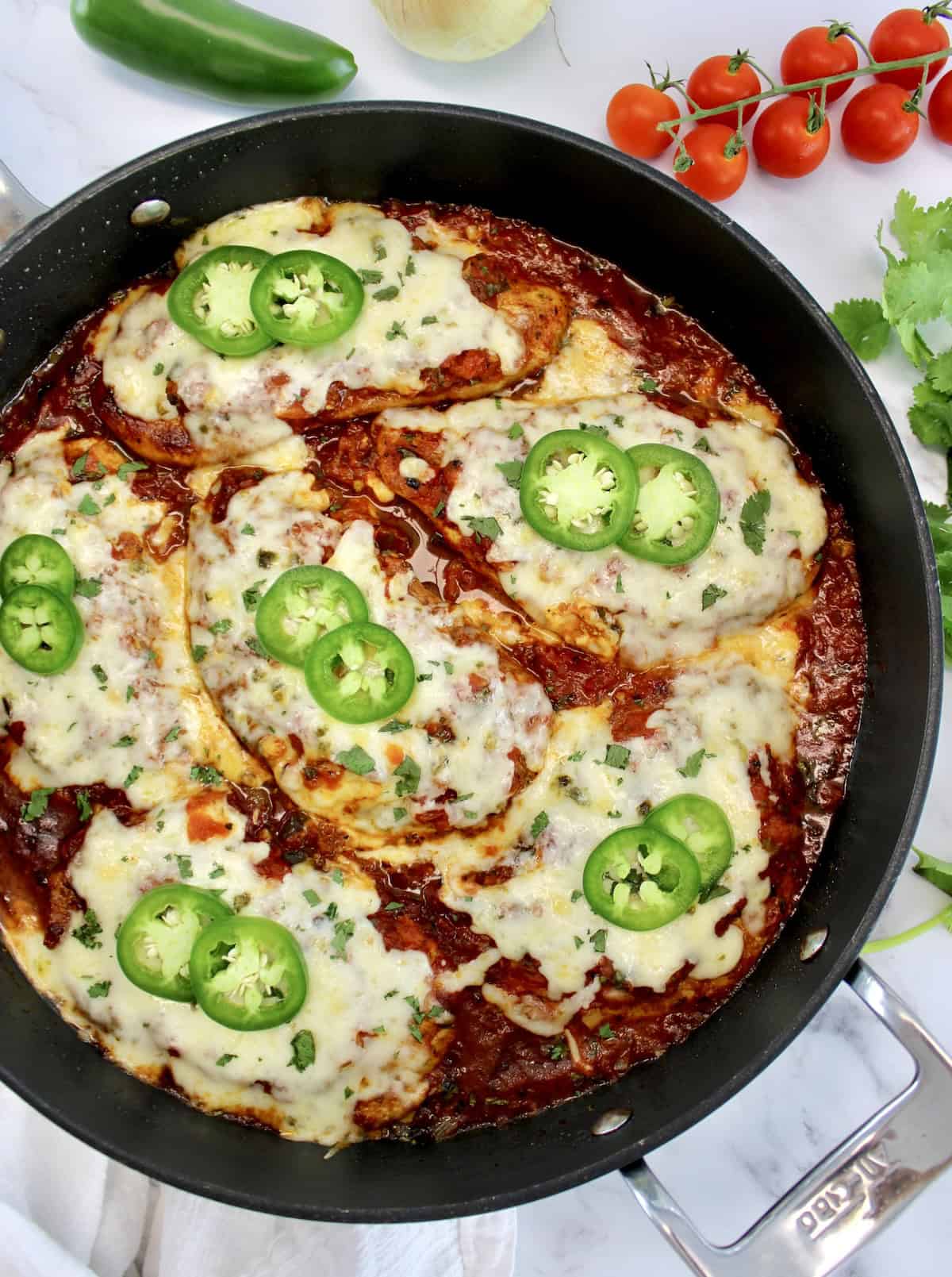 overhead view of Skillet Salsa Chicken with melted cheese and slices of jalapeno on top