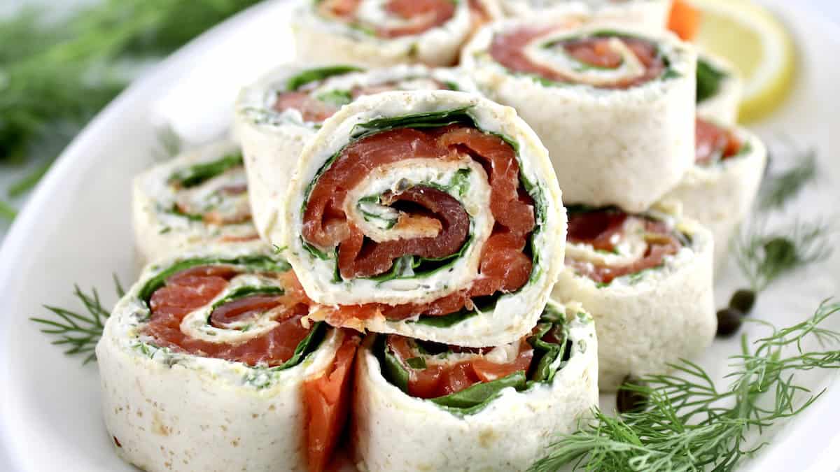 closeup of Smoked Salmon Pinwheels on white platter