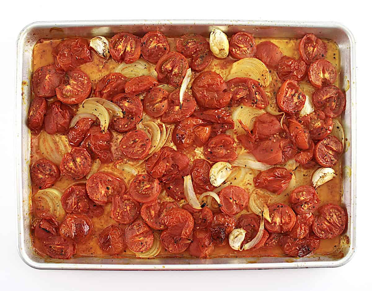 roasted tomatoes, onions and garlic on baking sheet