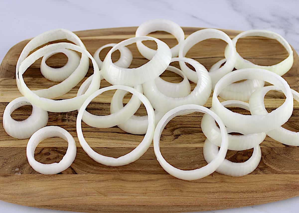 sliced onion rings on wooden cutting board