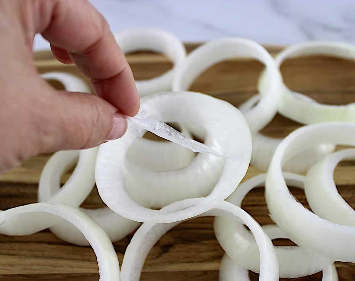 skin being pulled away from onion ring slice