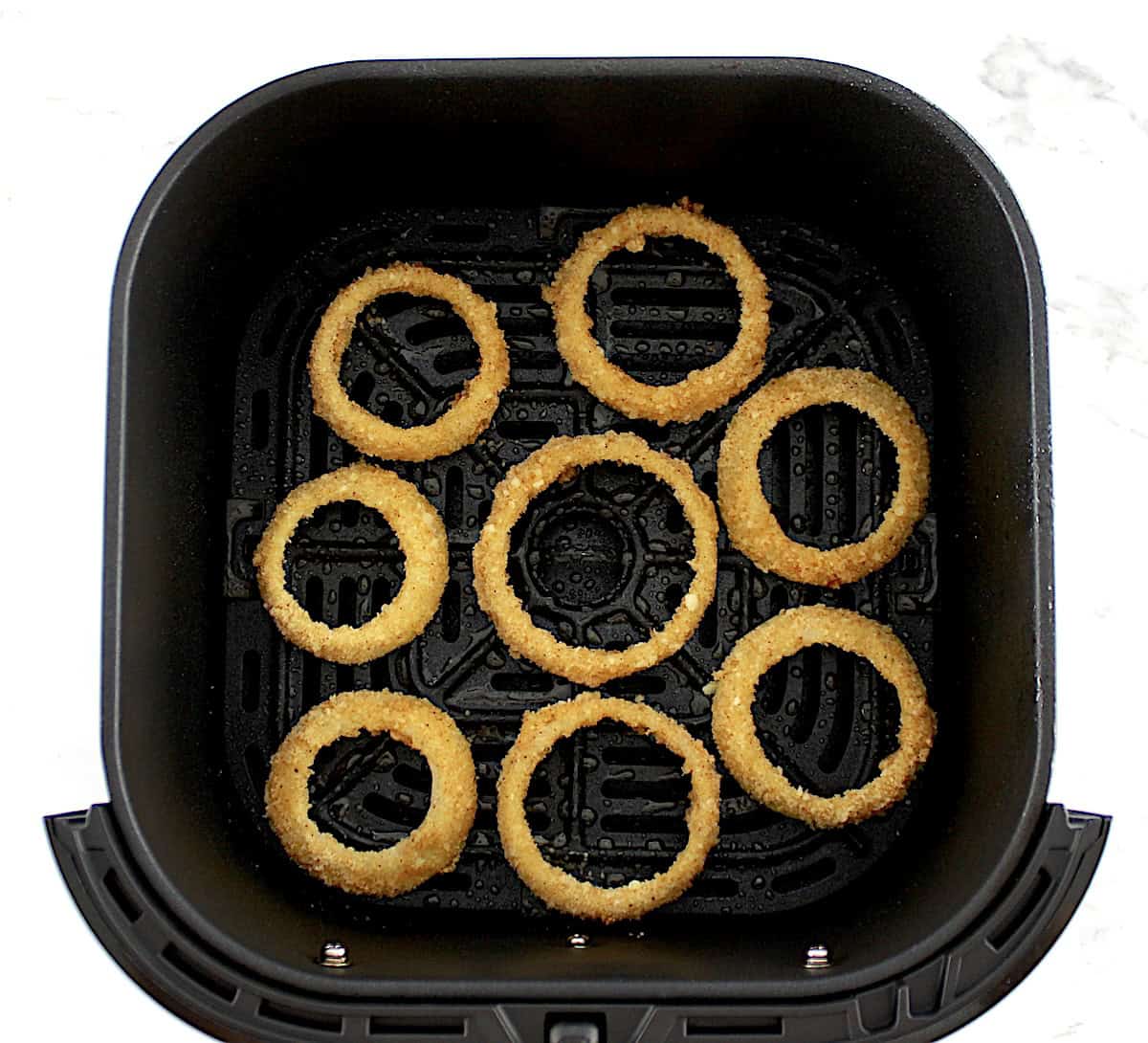 Air Fryer Onion Rings uncooked in air fryer basket