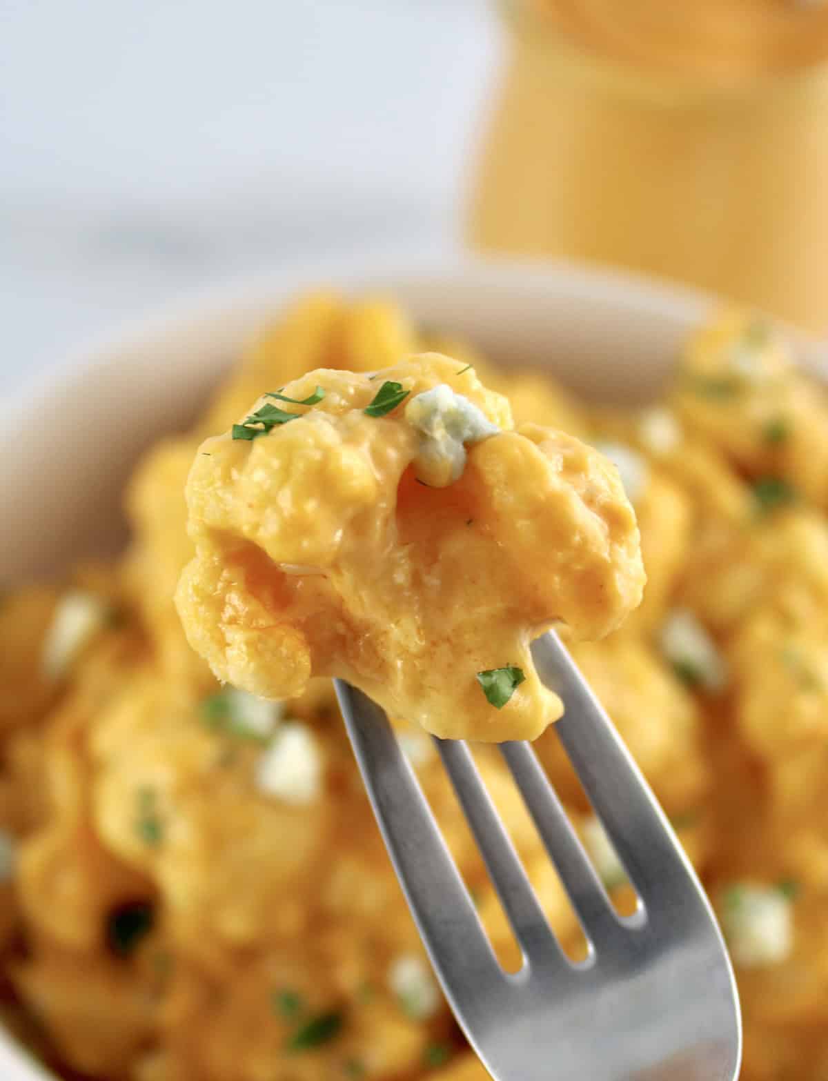 closeup of Buffalo Cauliflower Mac and Cheese floret on end of fork