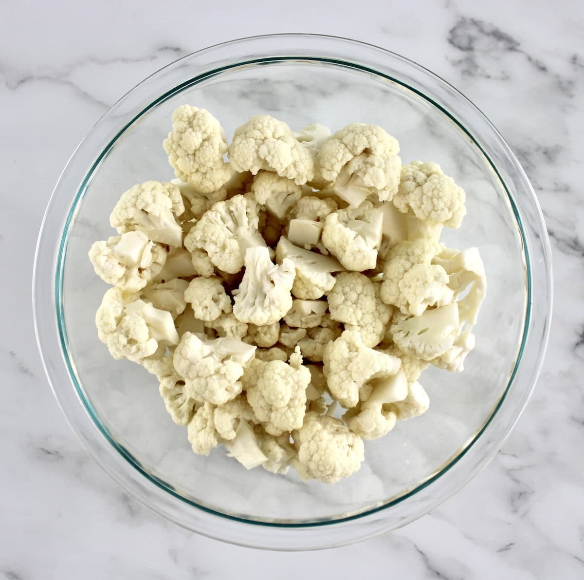 raw cauliflower florets in glass bowl