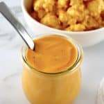 Buffalo Cheese Sauce and Dip in open glass jar with spoon sticking out