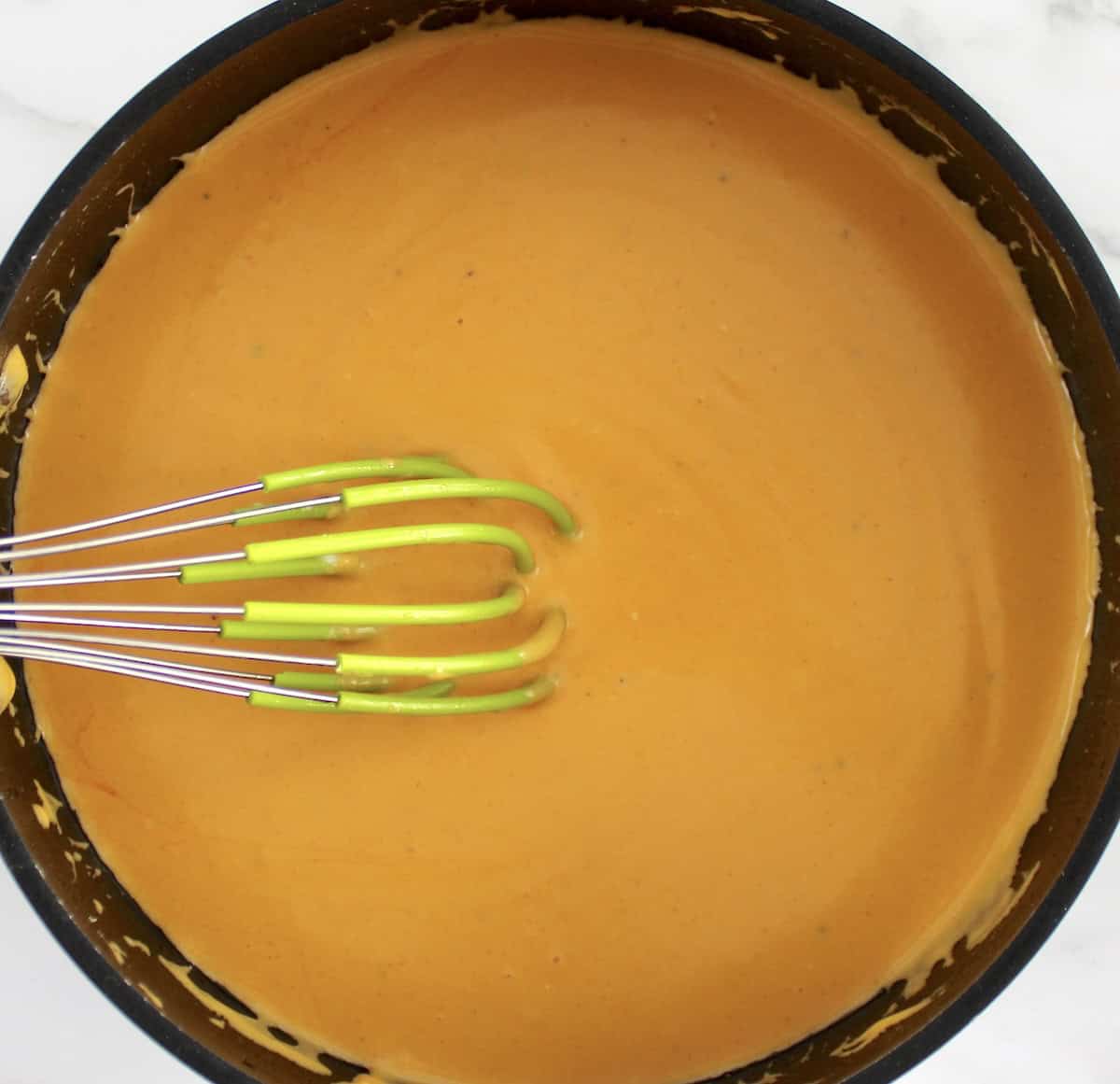 Buffalo Cheese Sauce and Dip in saucepan with whisk