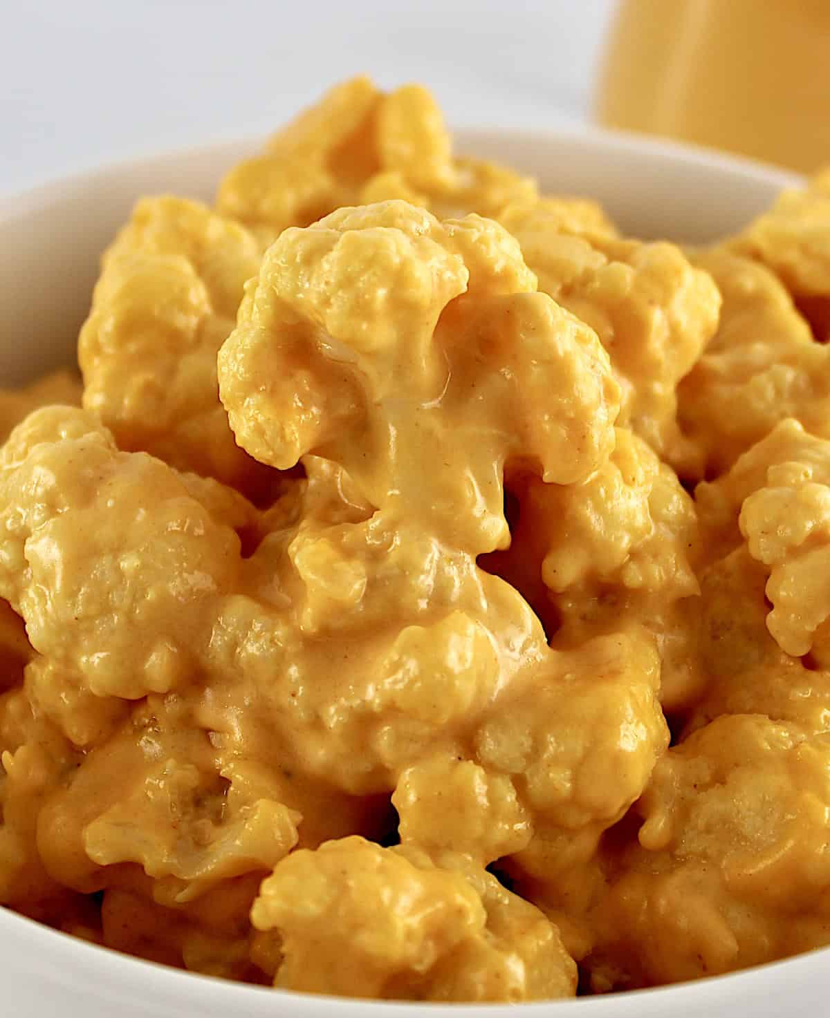 Buffalo Cheese Sauce and Dip over cauliflower in white bowl