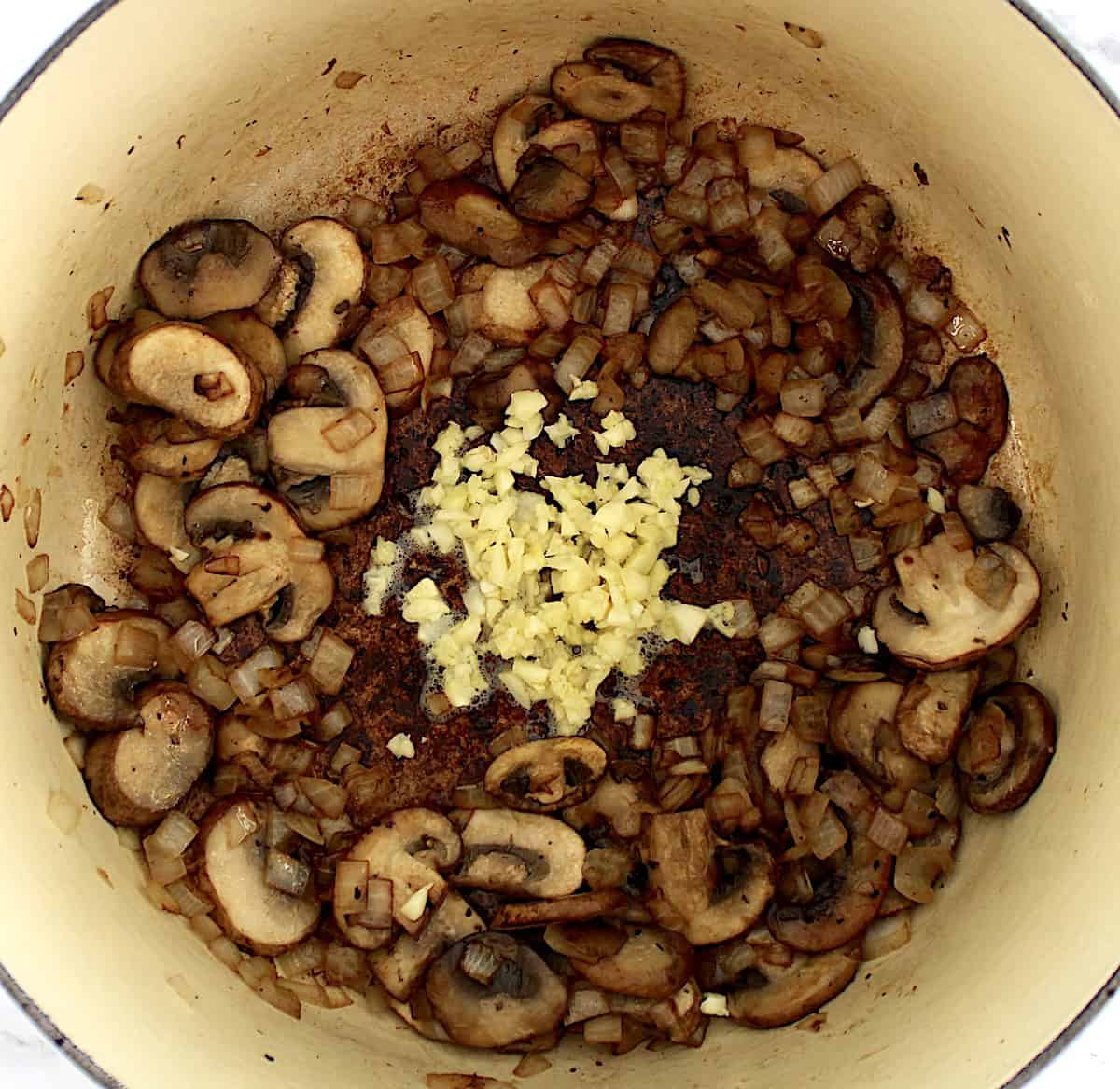 sauteed mushrooms and onions with minced garlic in center of pot