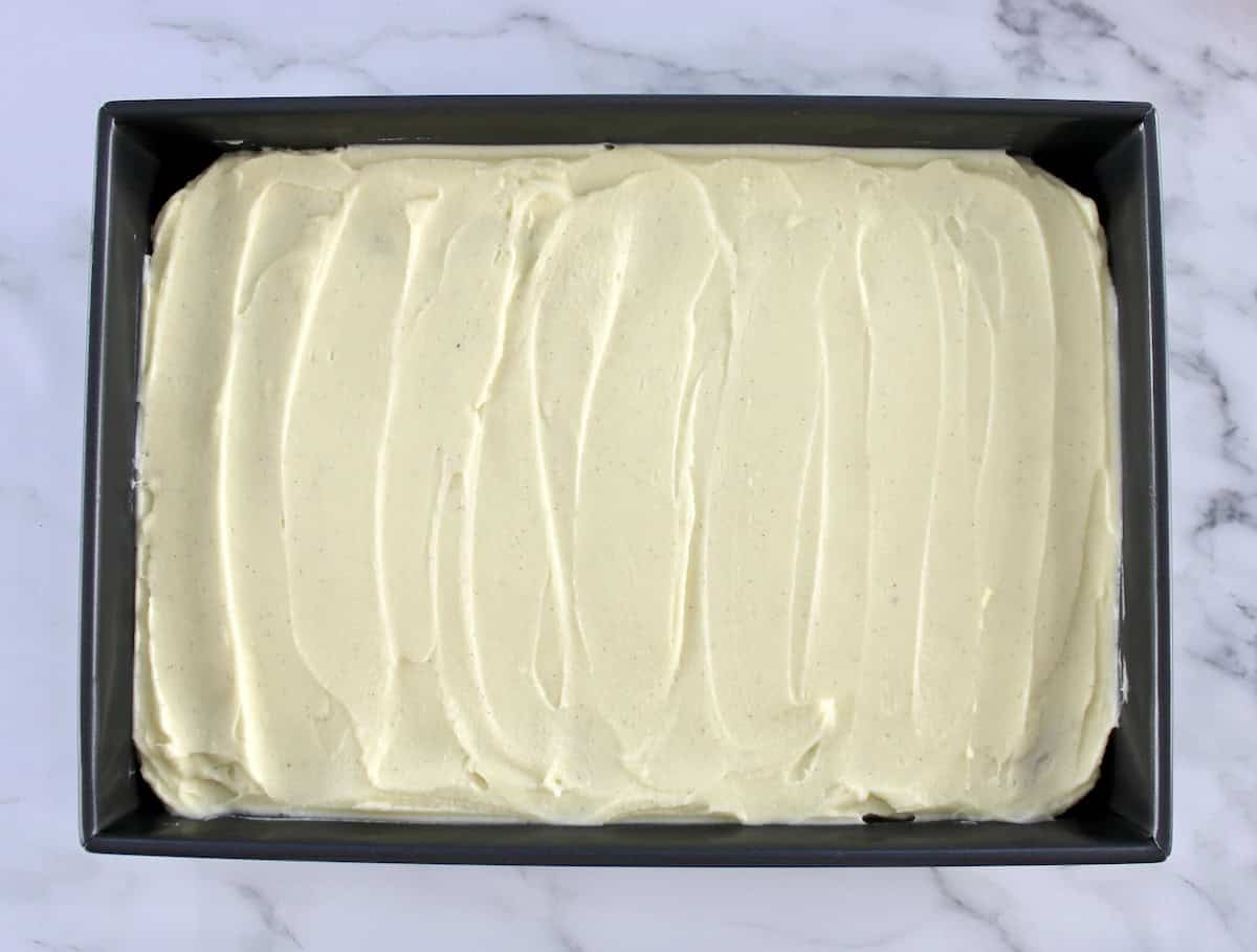 Pumpkin Spice Cake with vanilla frosting in baking pan